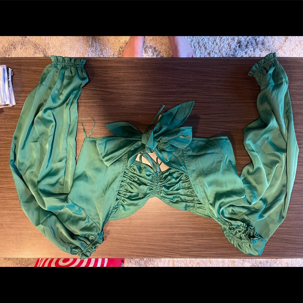 Silky dark green top with poofy sleeves and tie in the back.
